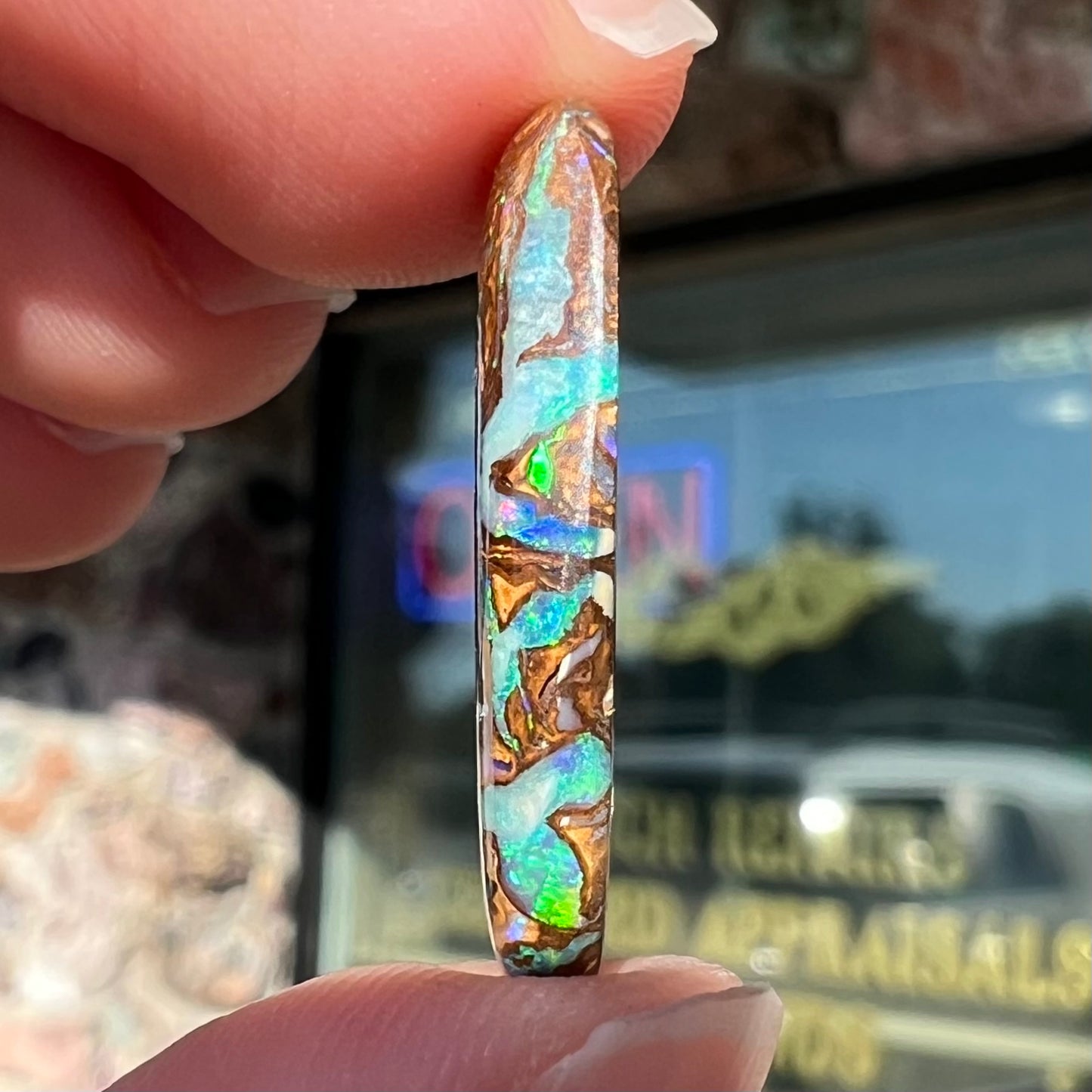 A loose, oval shaped Koroit boulder matrix opal.  The stone has patterns that resembles a rose.