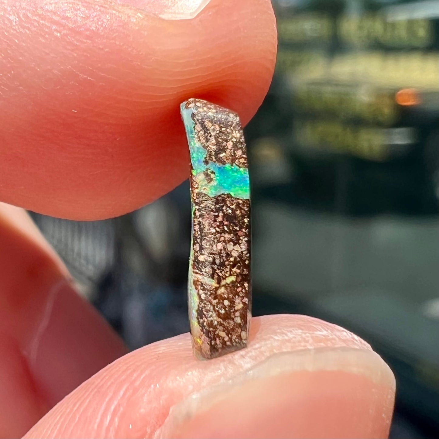 A loose, rectangular boulder opal stone from Quilpie, Australia.