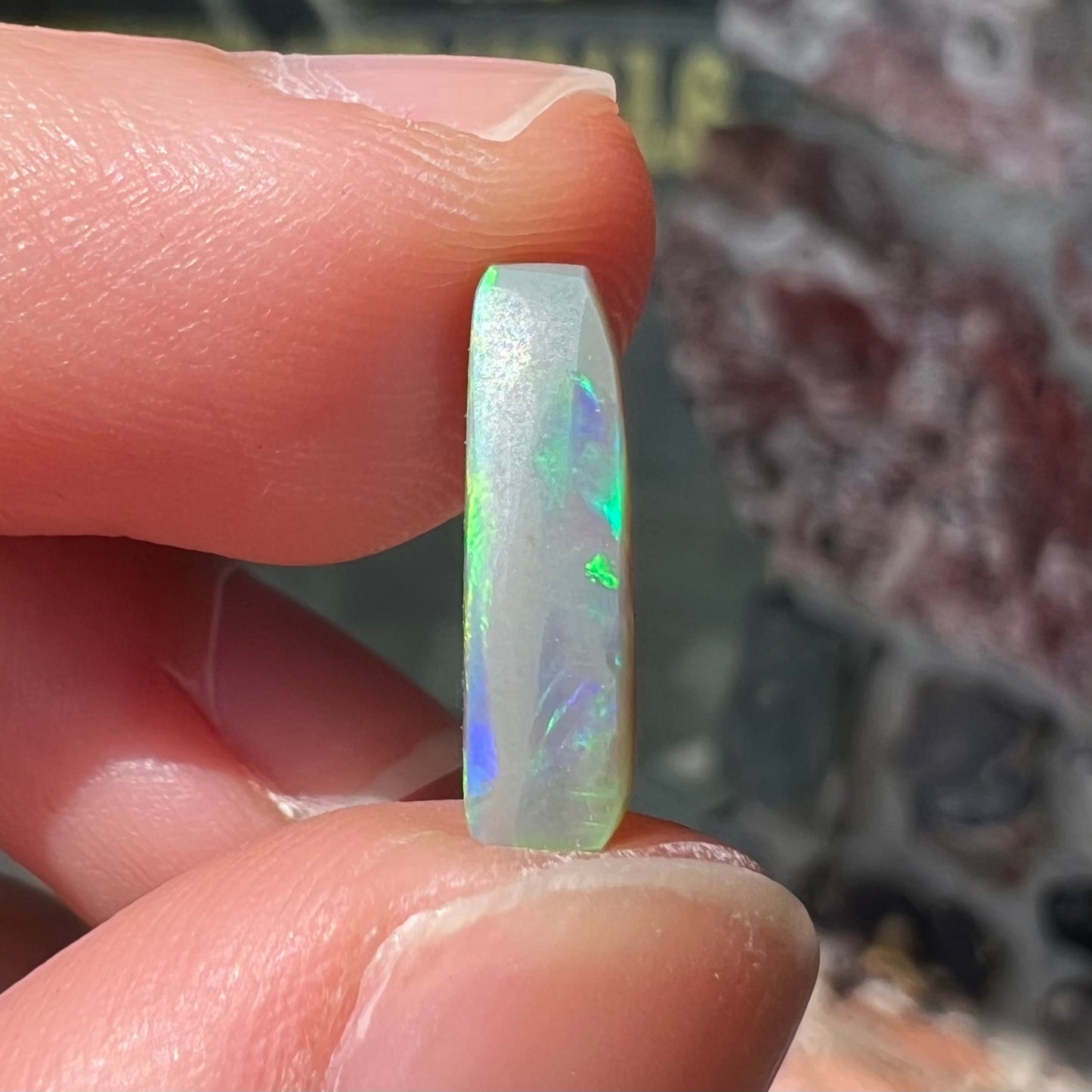 A loose, barrel shaped opal stone from Lightning Ridge, Australia.