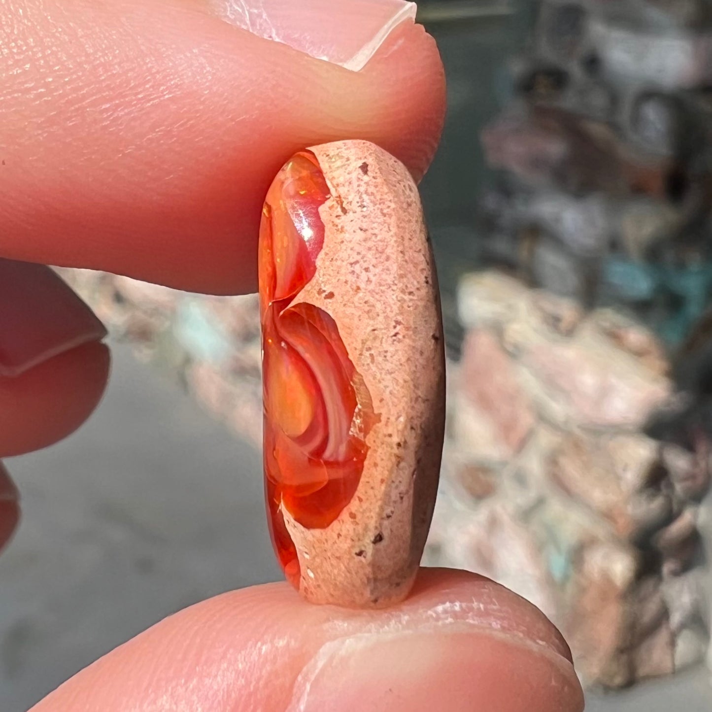 A loose Mexican matrix fire opal stone.  The opal is orange with green flashes.