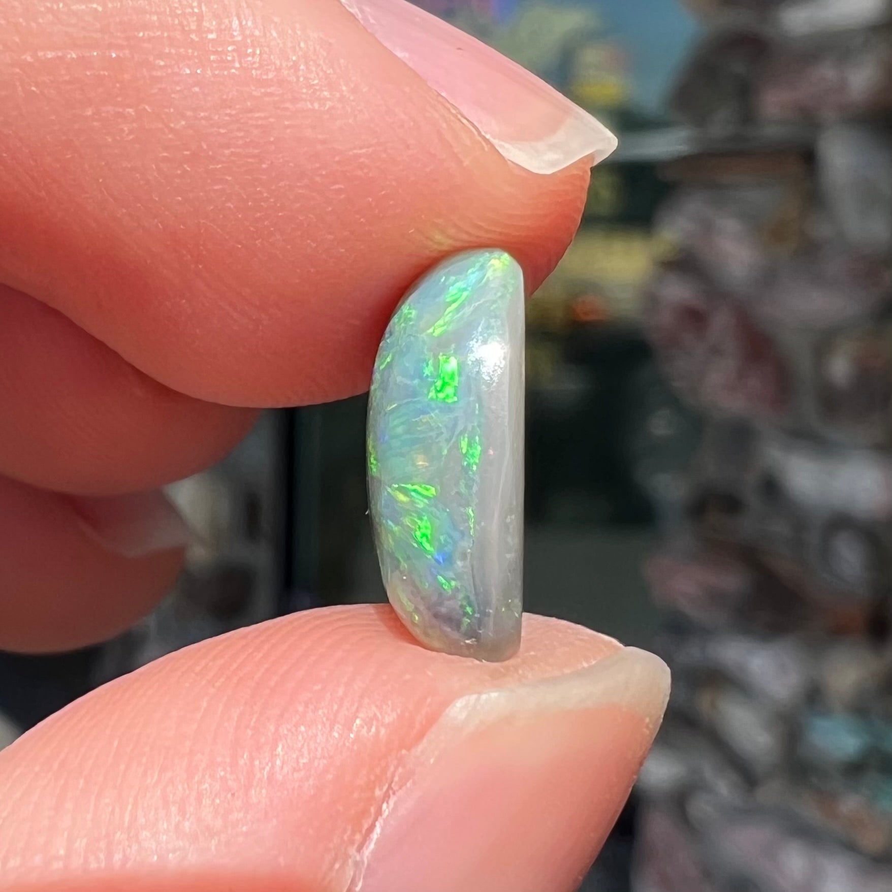 An oval cabochon cut 2.75ct semi-black opal gemstone from Lightning Ridge, Australia.