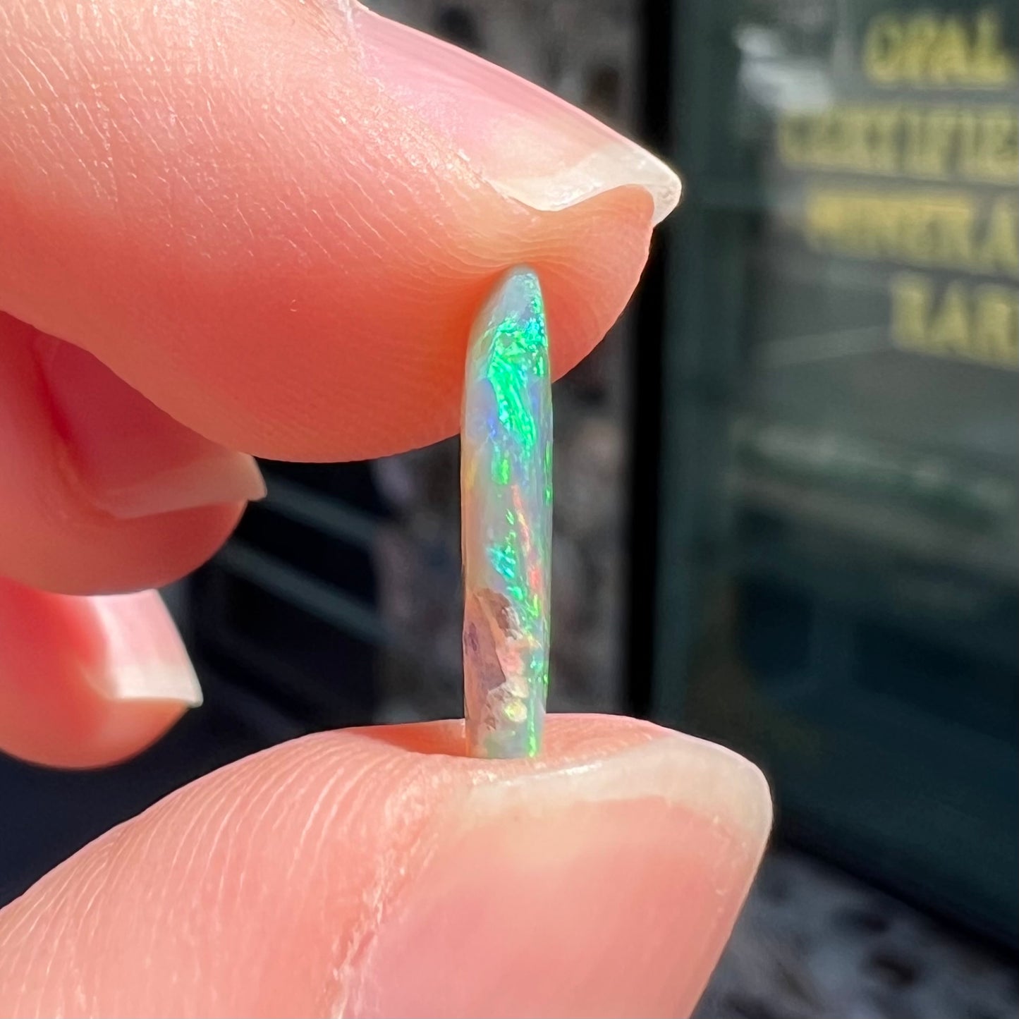 A loose, 1.27 carat Lightning Ridge crystal opal.  The opal has green colors.