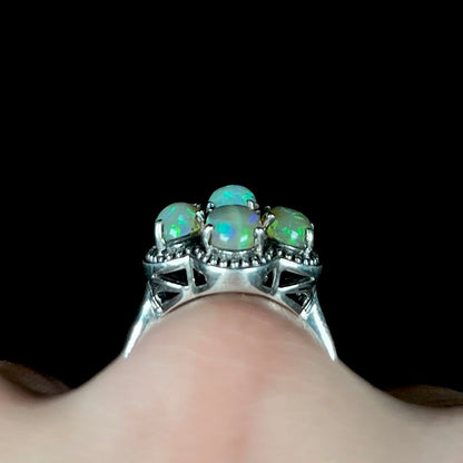 A sterling silver cluster ring prong-set with seven green Ethiopian fire opals.