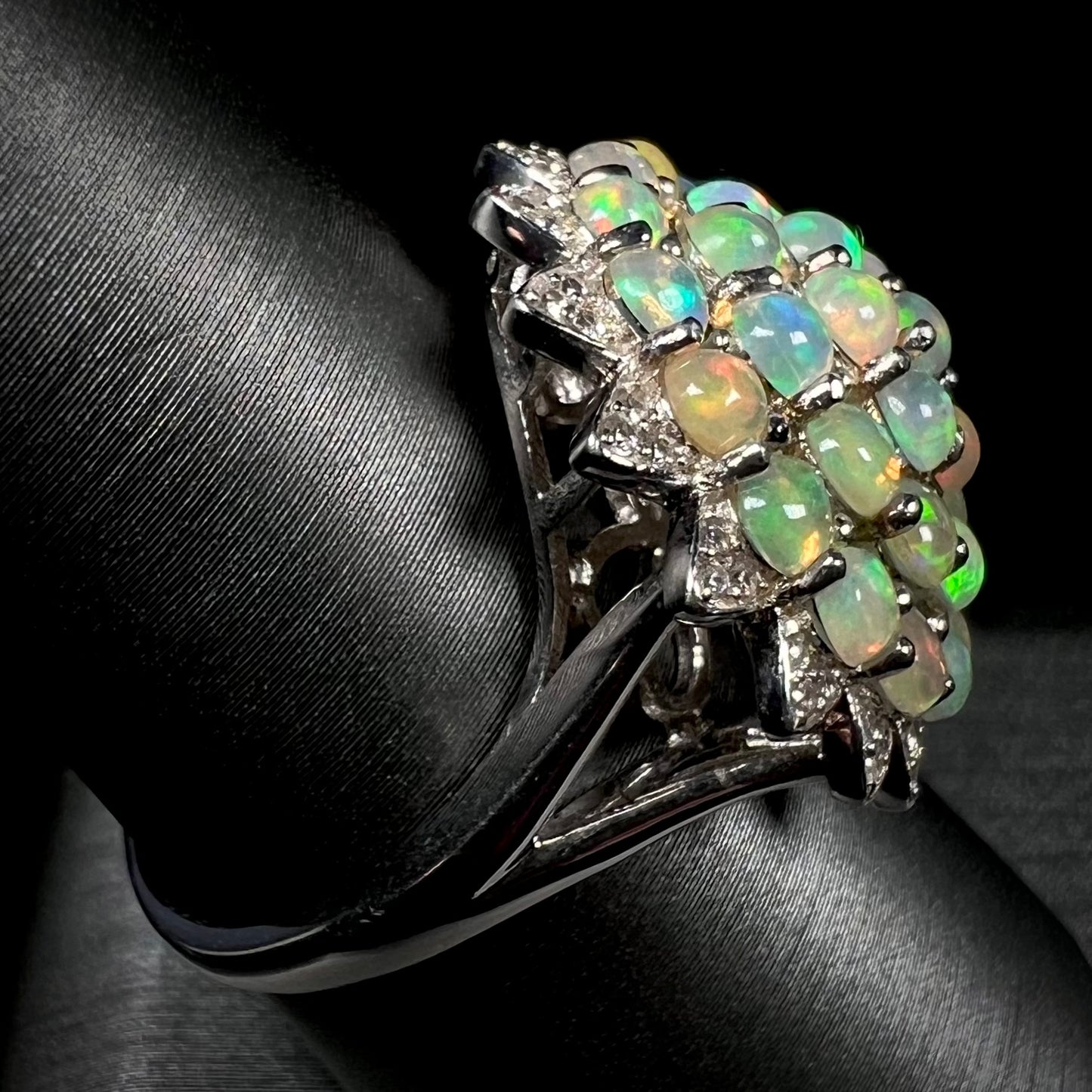 A sterling silver cluster flower ring mounted with 33 round Ethiopian fire opals.