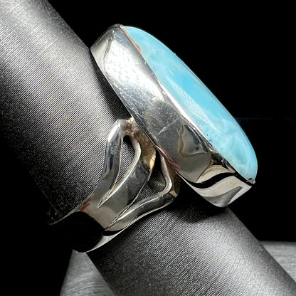 A ladies' large, pear shaped larimar solitaire ring in sterling silver.  The larimar stone measures an inch long.