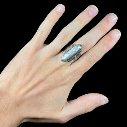 A Boho Chic style sterling silver solitaire ring set with an oval shaped, metallic silver gray mabe pearl.