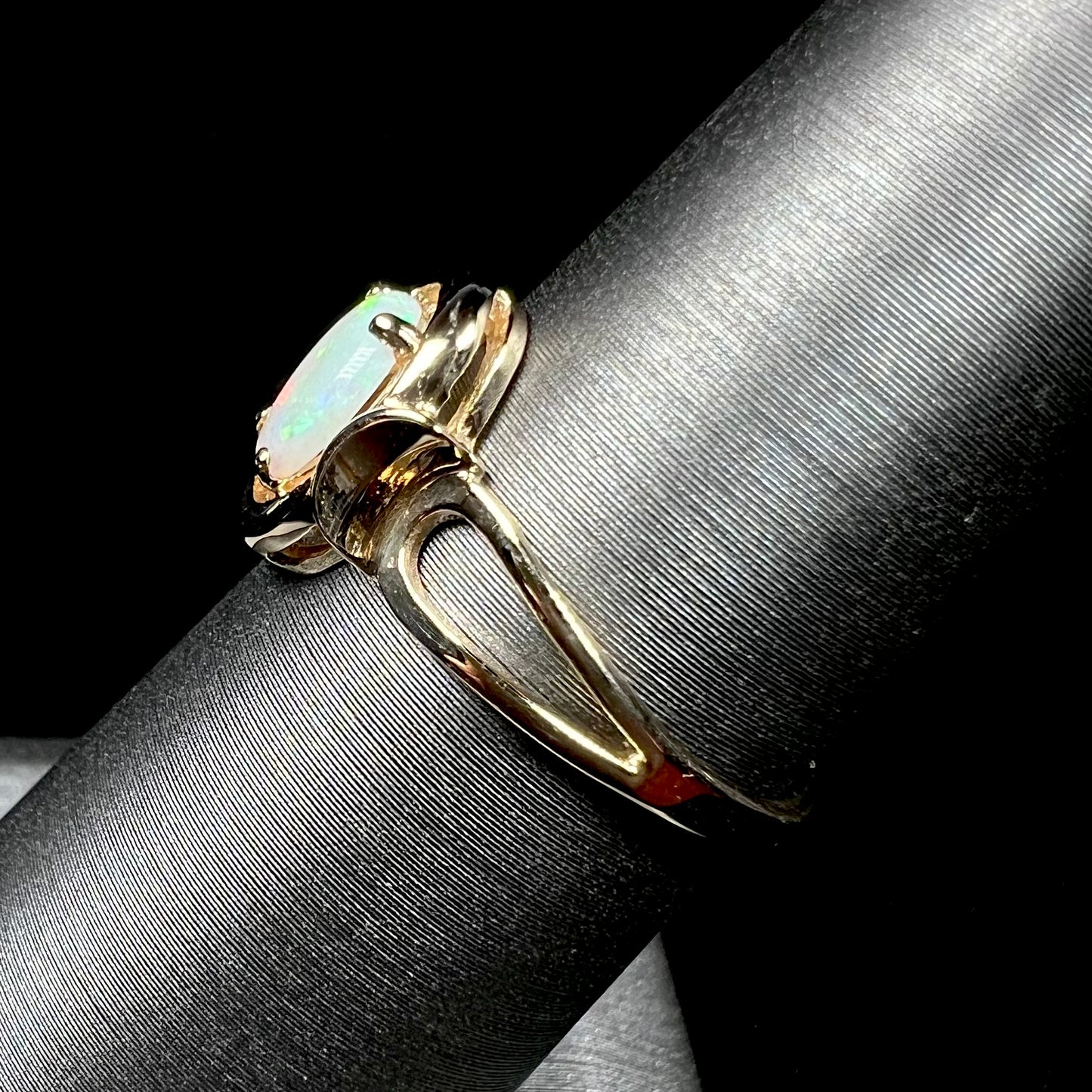 A 14 karat yellow gold open-shank design Australian crystal opal ring.