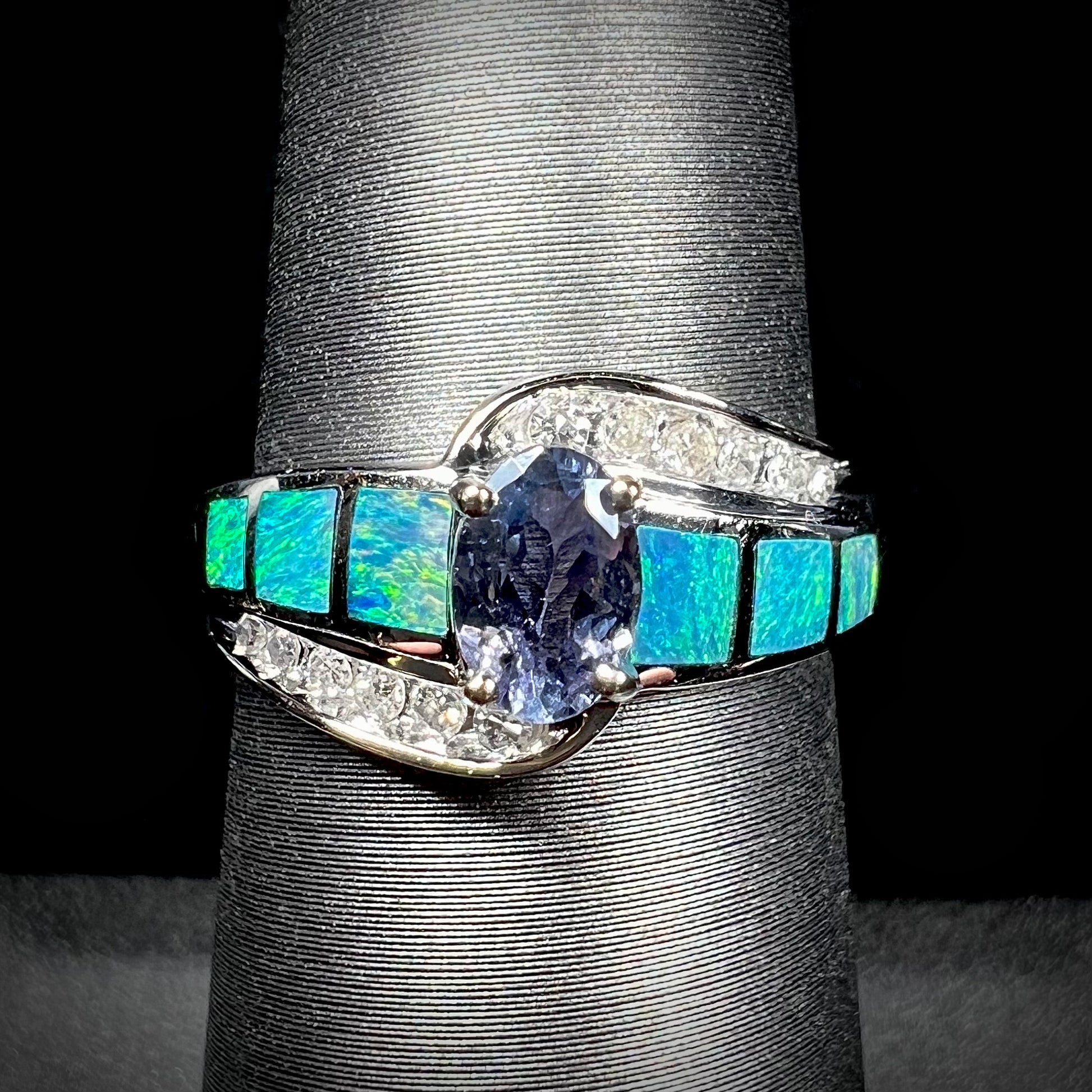 A ladies' white gold tanzanite ring with black opal doublet and diamond accents.