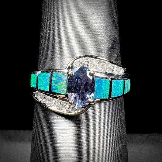 A ladies' white gold tanzanite ring with black opal doublet and diamond accents.