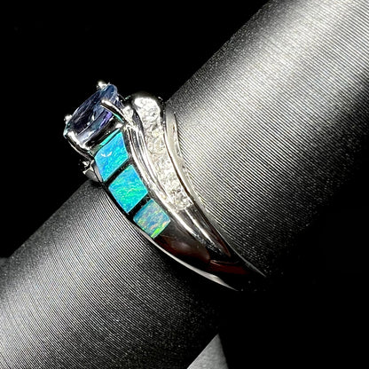 A ladies' white gold tanzanite ring with black opal doublet and diamond accents.