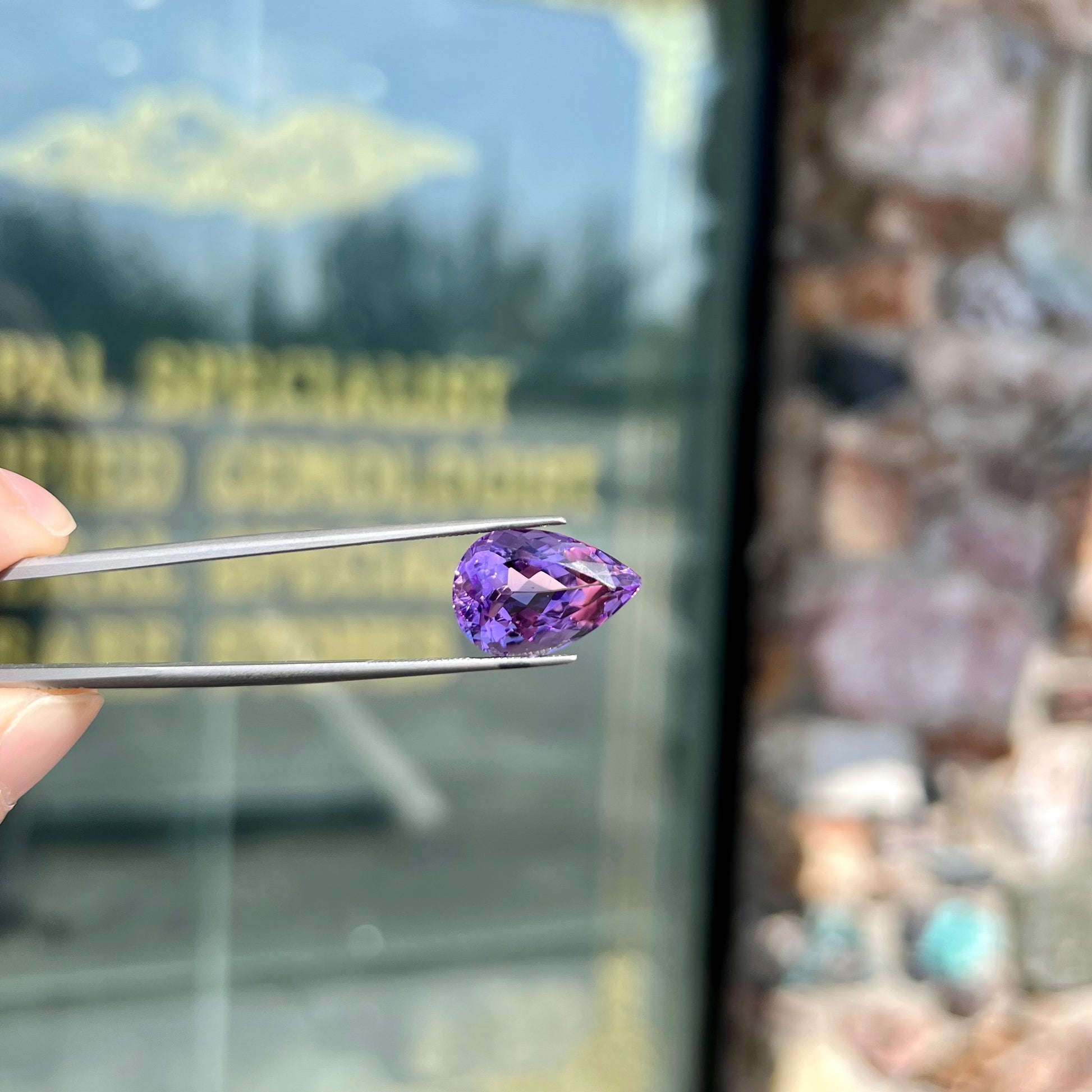 A loose, pear shaped amethyst gemstone.  The stone is a medium purple color.