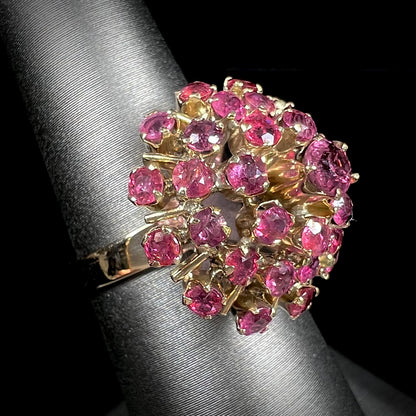 A ladies' vintage Thai princess ring set with round cut purplish red rubies.