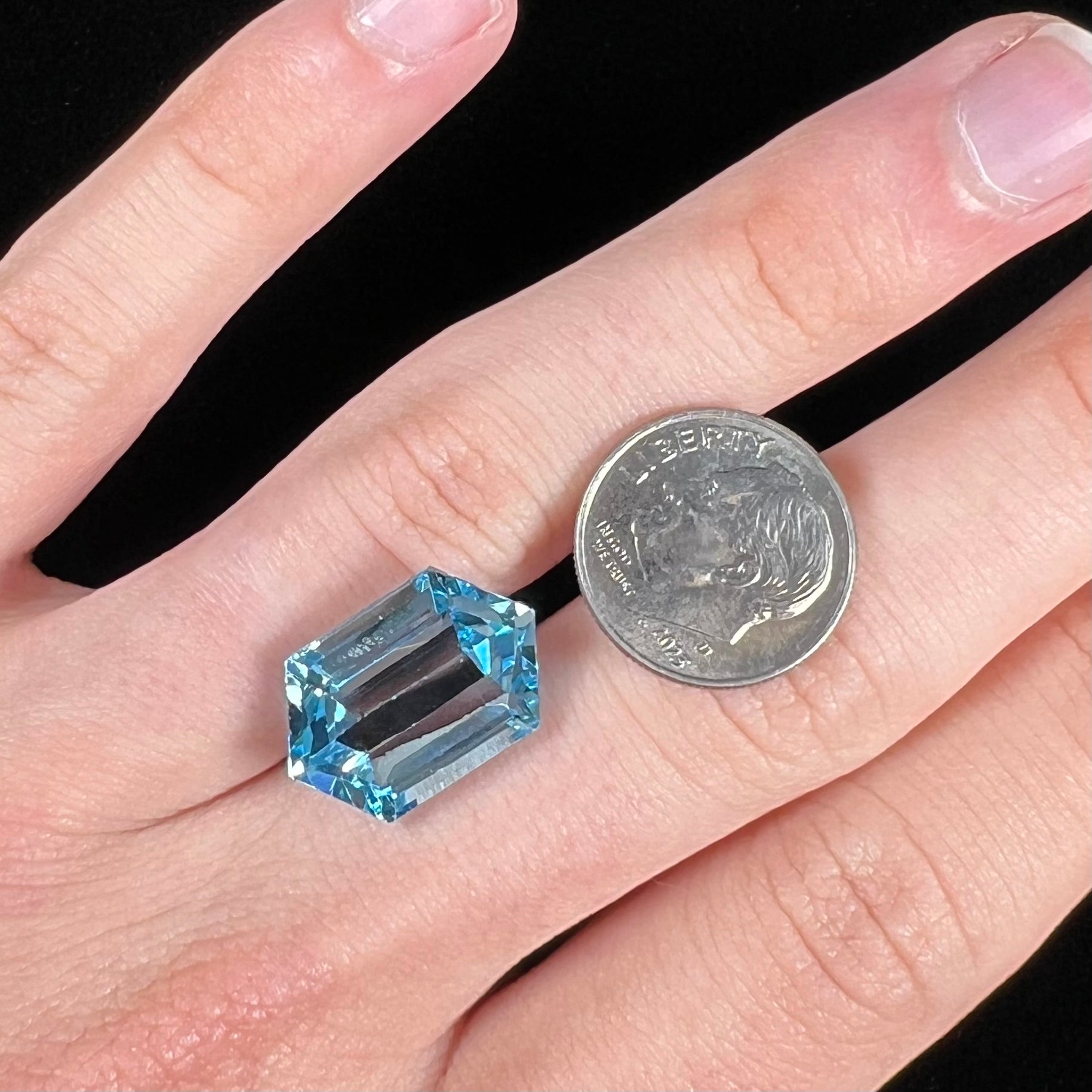 A loose, dutchess cut blue topaz gemstone.  The stone is a sky blue color.