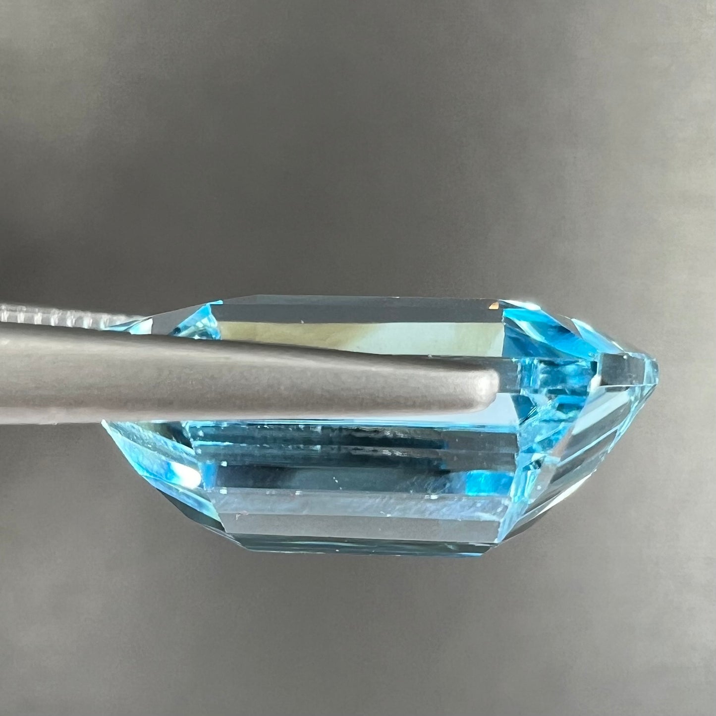 A loose, dutchess cut blue topaz gemstone.  The stone is a sky blue color.