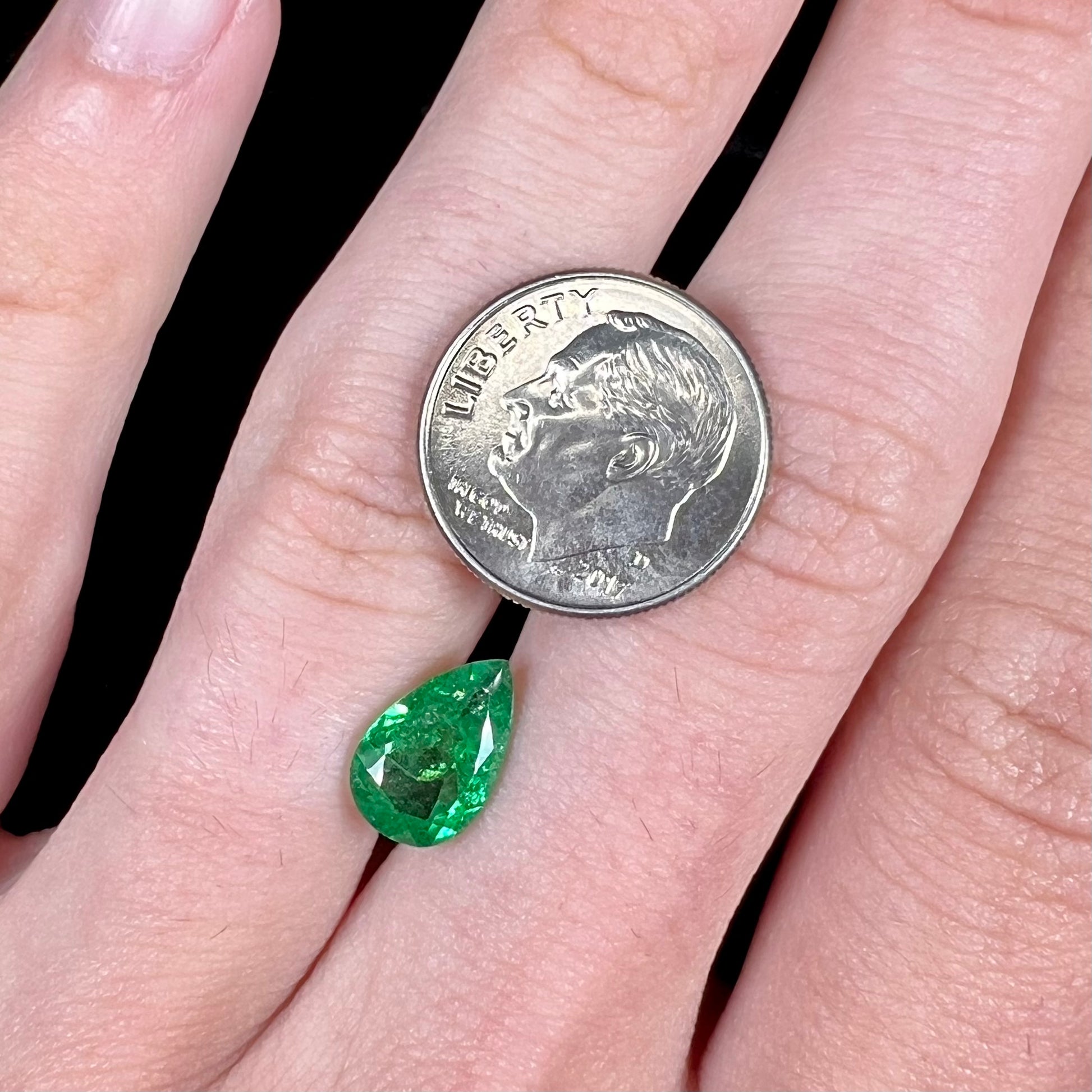 A loose, pear shaped tsavorite garnet gemstone.  The stone is vivid green color.