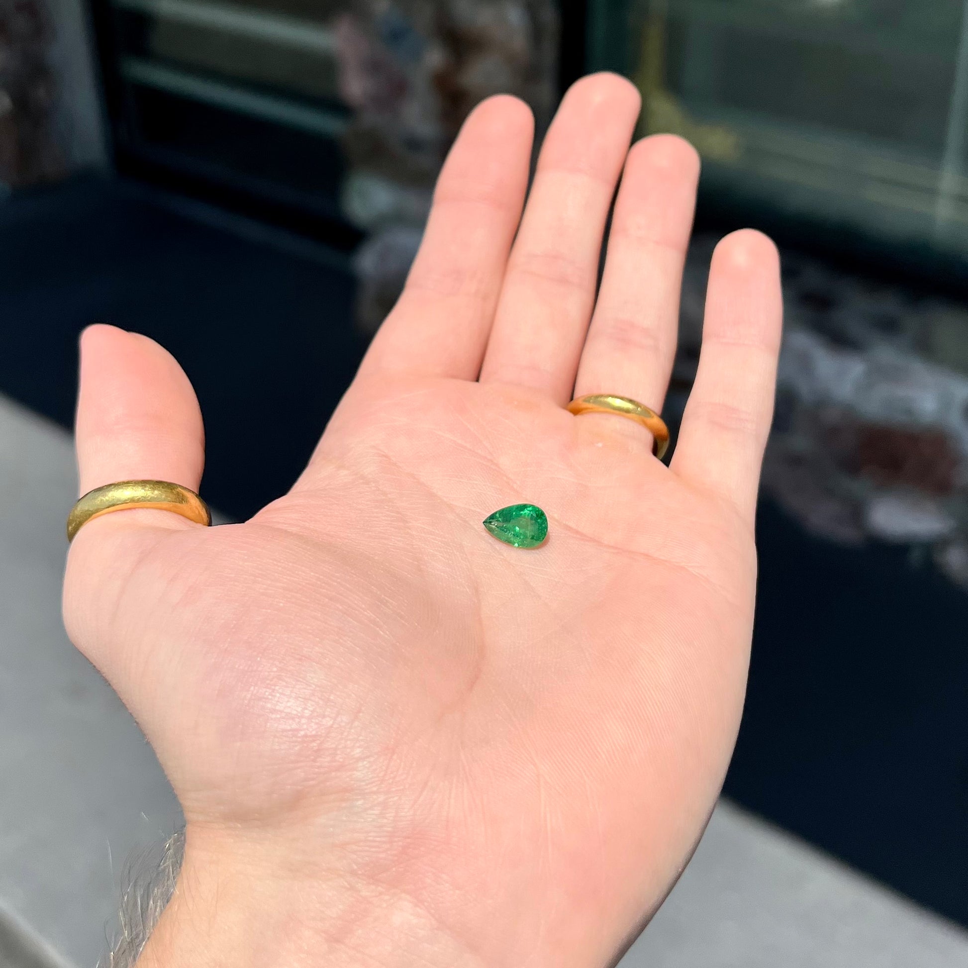 A loose, pear shaped tsavorite garnet gemstone.  The stone is vivid green color.