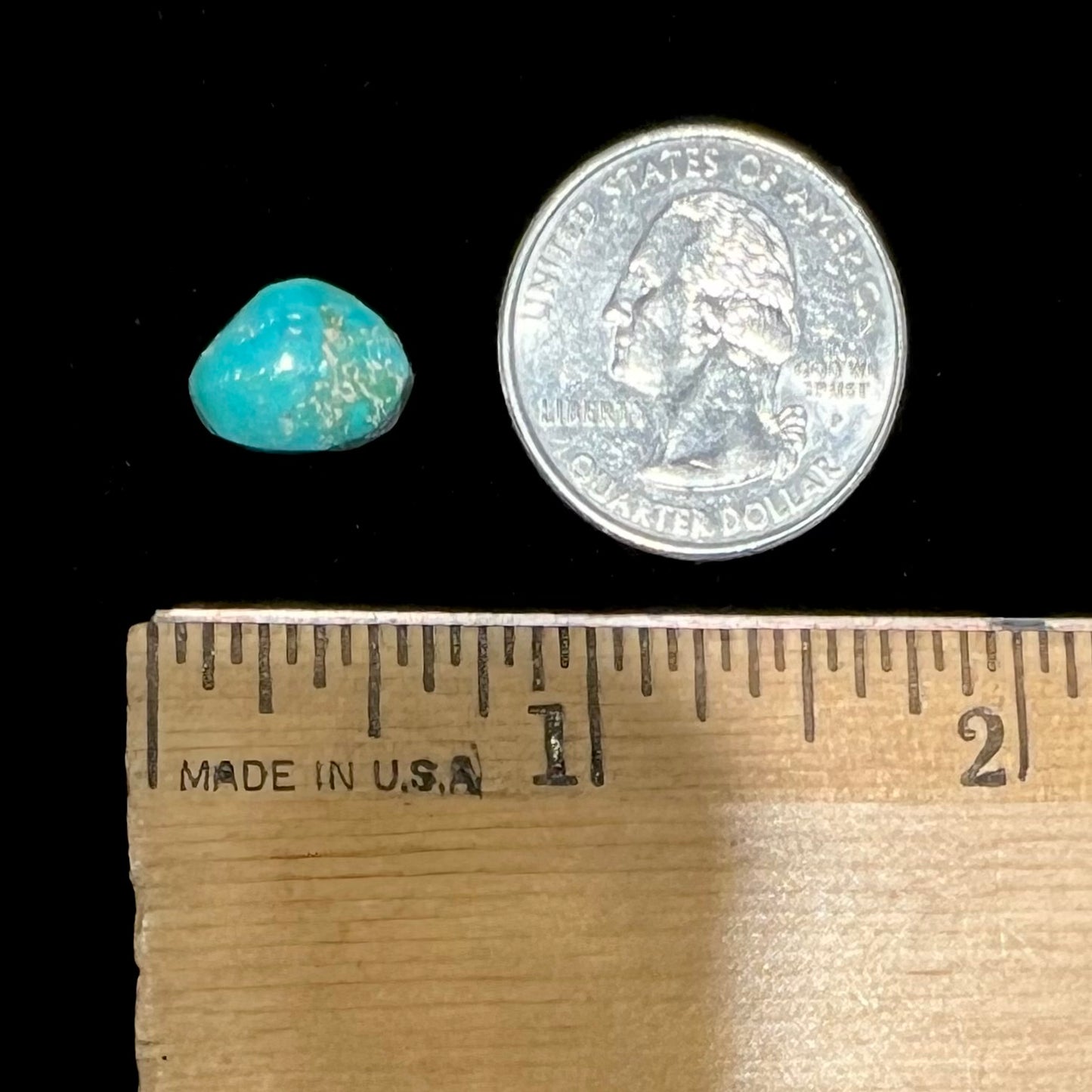 A loose, freeform cut Pilot Mountain turquoise cabochon.  The stone is greenish blue.