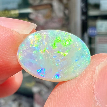 A double-sided opal stone from Coober Pedy, Australia.  The opal plays green, blue, and orange colors from the front and the back.