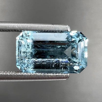 A loose, faceted emerald cut aquamarine stone.  The stone is icy blue in color, indicative of Vietnamese origin.