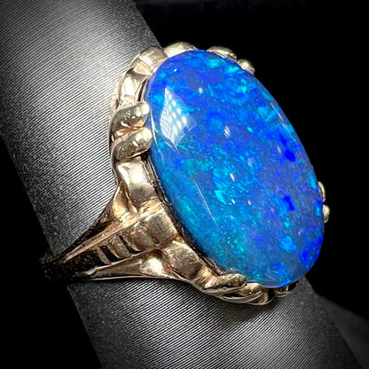 A ladies' vintage, 1940's style black opal doublet ring in yellow gold.