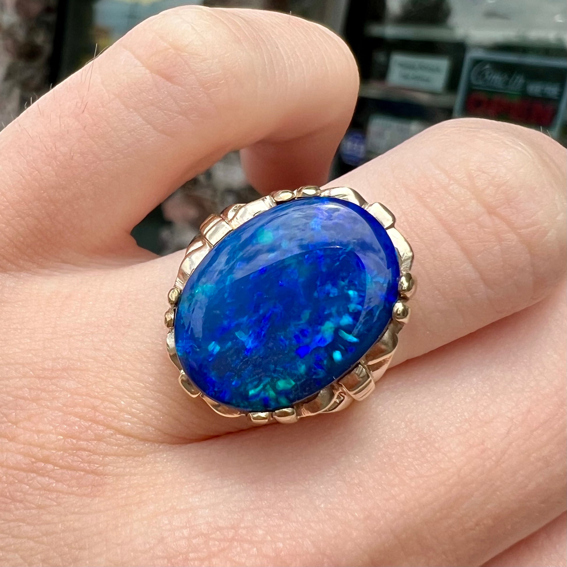 A ladies' vintage, 1940's style black opal doublet ring in yellow gold.