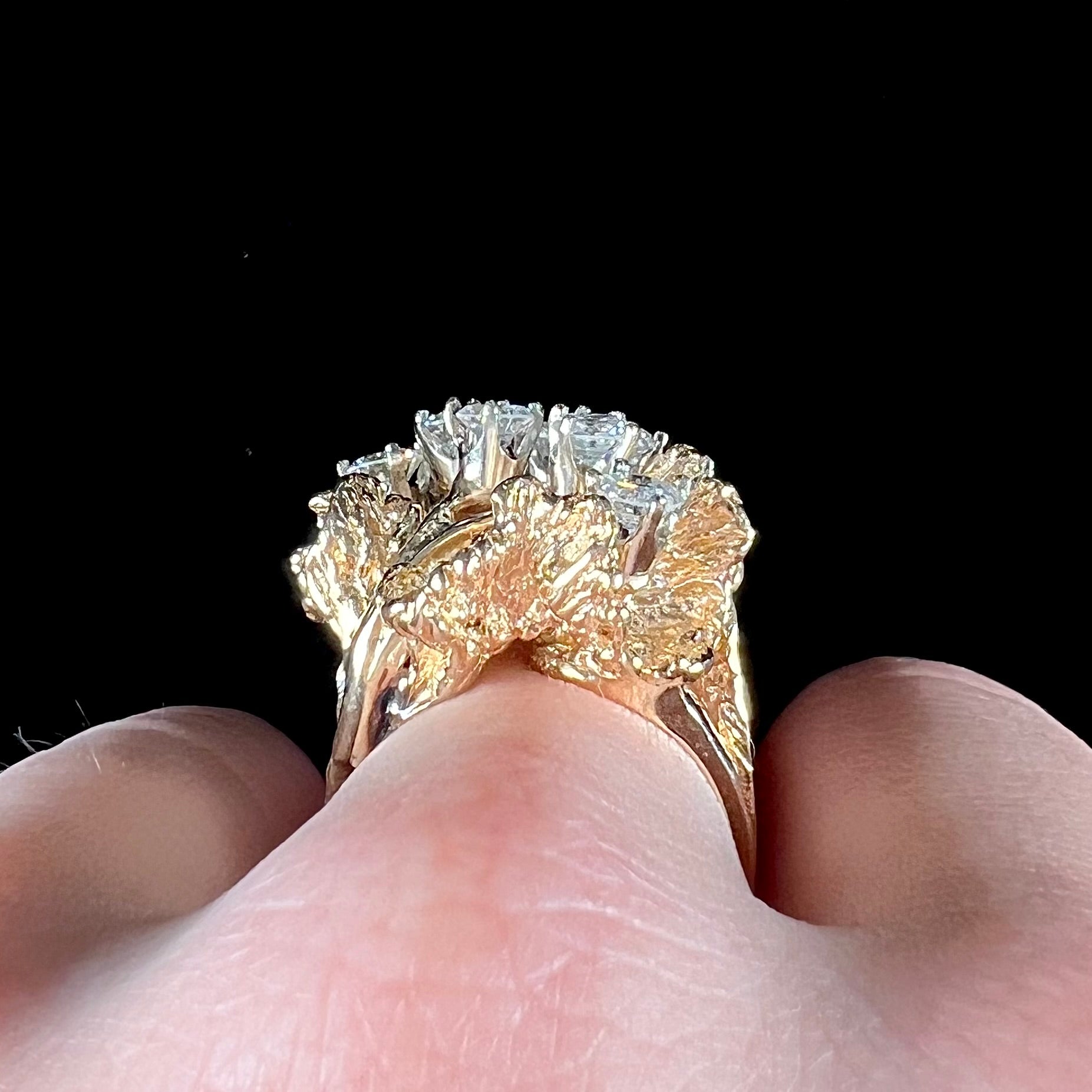 A ladies' 1950's style yellow gold and diamond cluster ring.  The ring is shaped like a leaf with 10 round diamonds set in it.