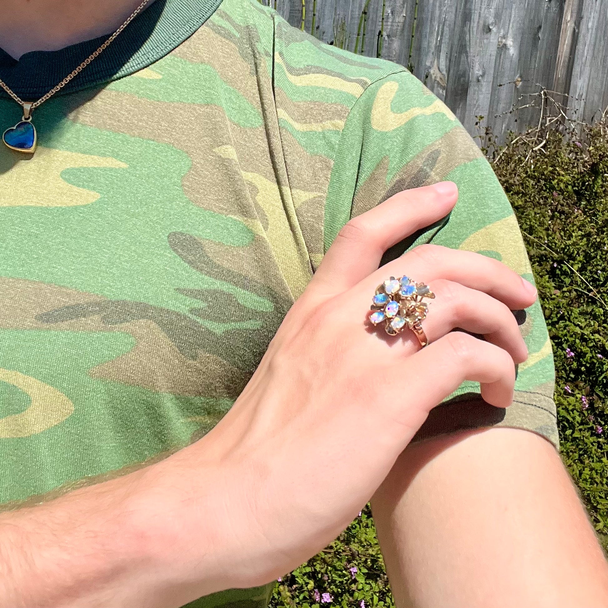 A ladies' vintage, modernist style opal cluster ring in yellow gold.  The ring is tall with a high profile.