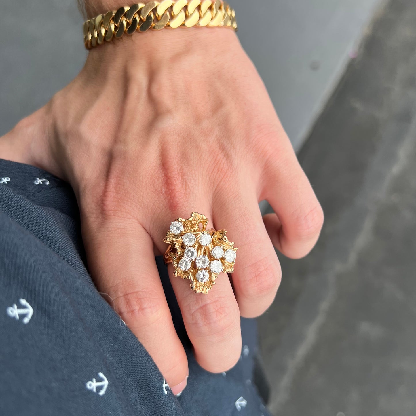 A ladies' 1950's style yellow gold and diamond cluster ring.  The ring is shaped like a leaf with 10 round diamonds set in it.