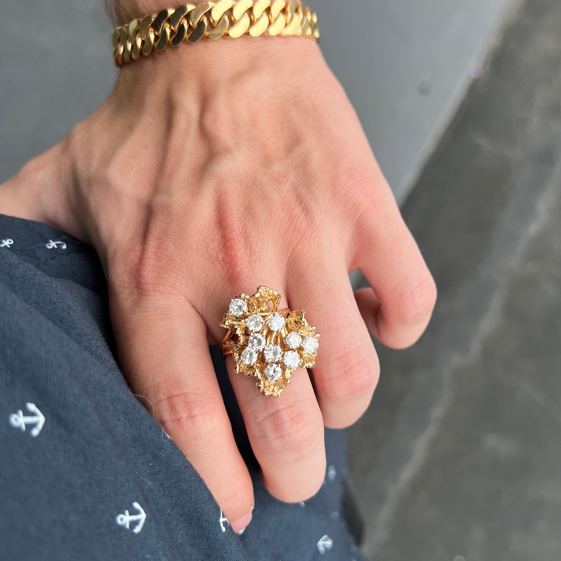 A ladies' 1950's style yellow gold and diamond cluster ring.  The ring is shaped like a leaf with 10 round diamonds set in it.