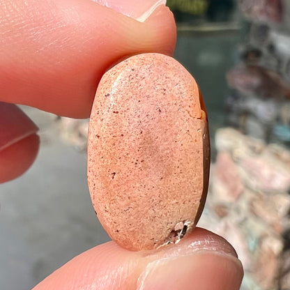 A loose Mexican matrix fire opal stone.  The opal is orange with green flashes.