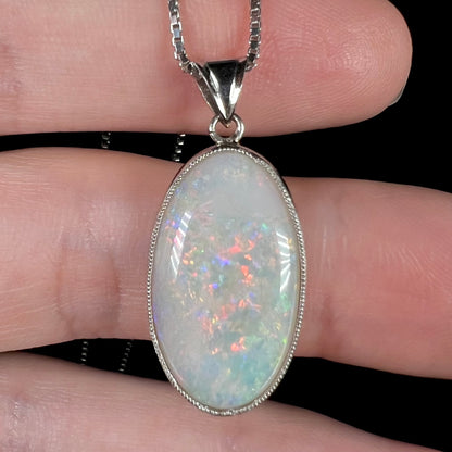 A platinum pendant mounted with an oval cut Australian white opal.