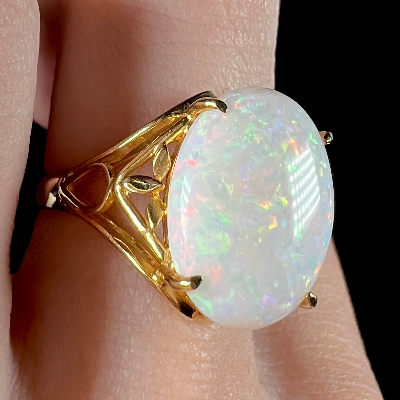 A yellow gold solitaire cocktail ring mounted with a natural white opal from Coober Pedy, Australia.