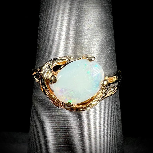 An organic-style yellow gold ring mounted with a white opal.