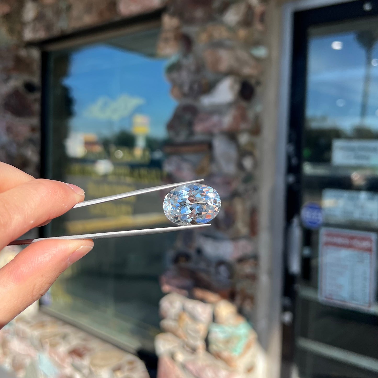 A loose, faceted oval cut white topaz gemstone.  The stone is large in size.