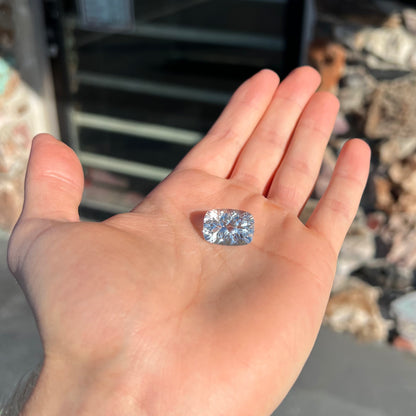 A loose, cushion laser cut white topaz stone.