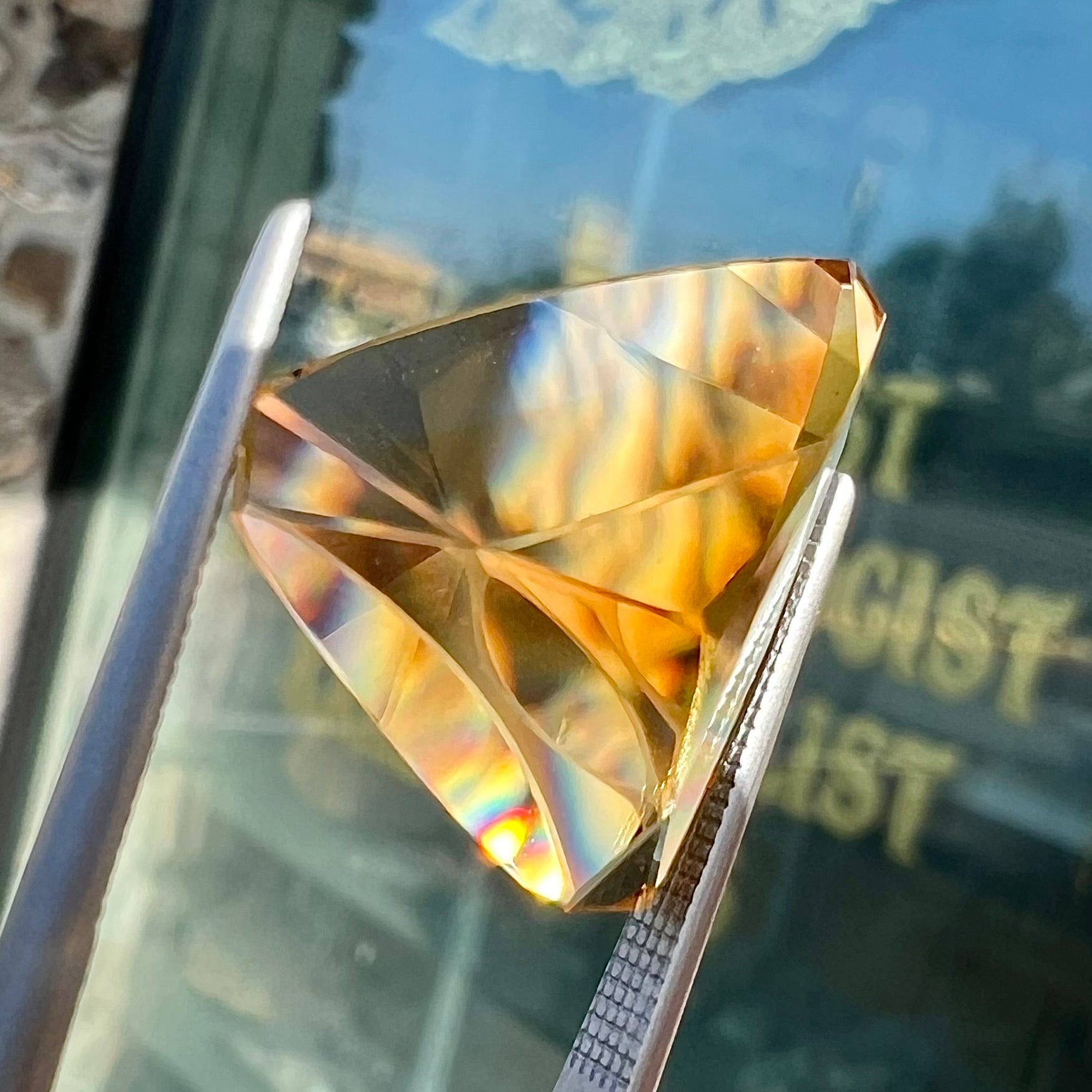 A loose, triangular fantasy cut yellow citrine stone cut by Arthur Lee Anderson.