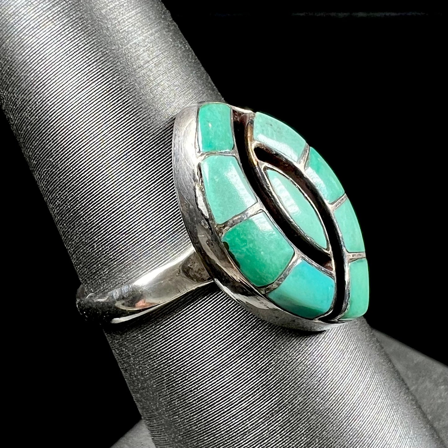 Vintage sterling silver Zuni Indian ring inlay set with green turquoise stones in the motif of a hummingbird.