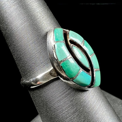 Vintage sterling silver Zuni Indian ring inlay set with green turquoise stones in the motif of a hummingbird.