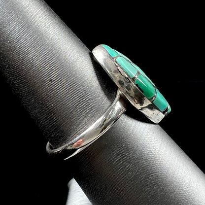 Vintage sterling silver Zuni Indian ring inlay set with green turquoise stones in the motif of a hummingbird.