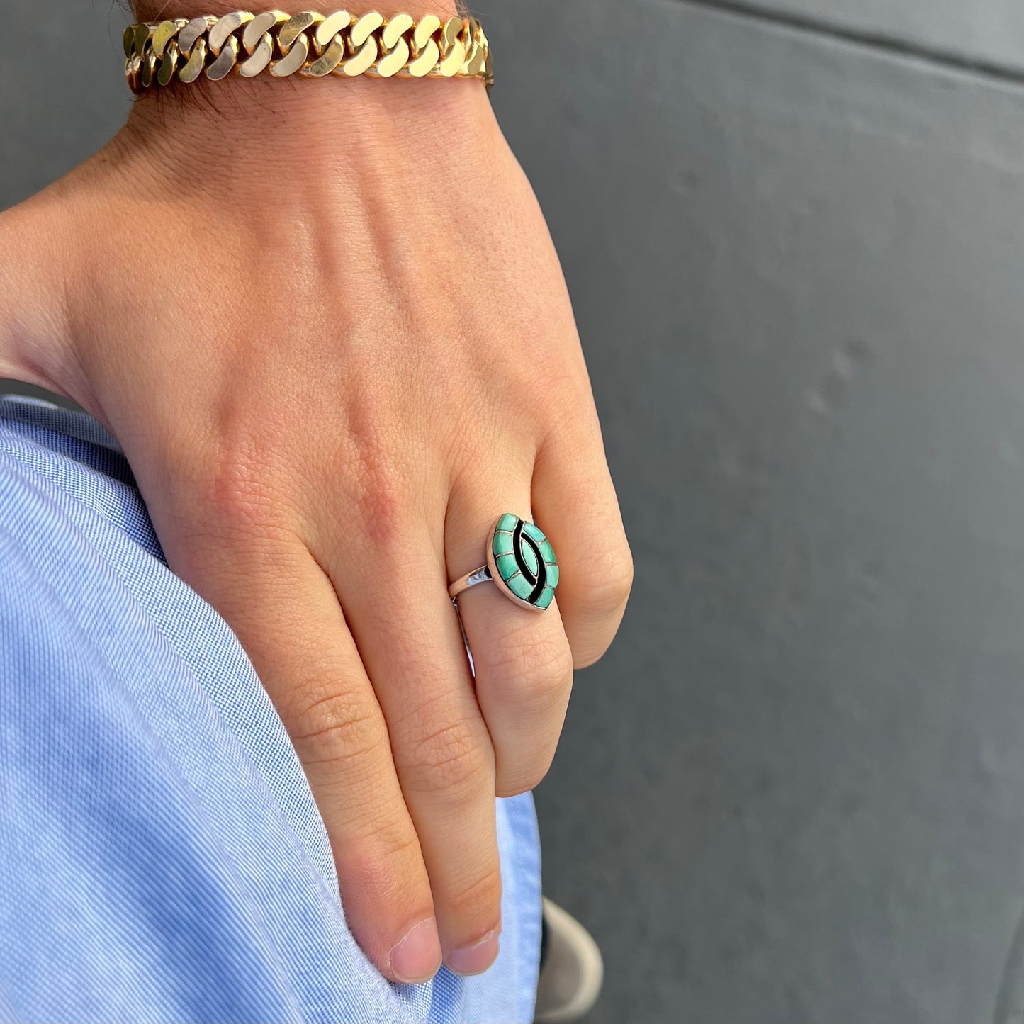 Vintage sterling silver Zuni Indian ring inlay set with green turquoise stones in the motif of a hummingbird.