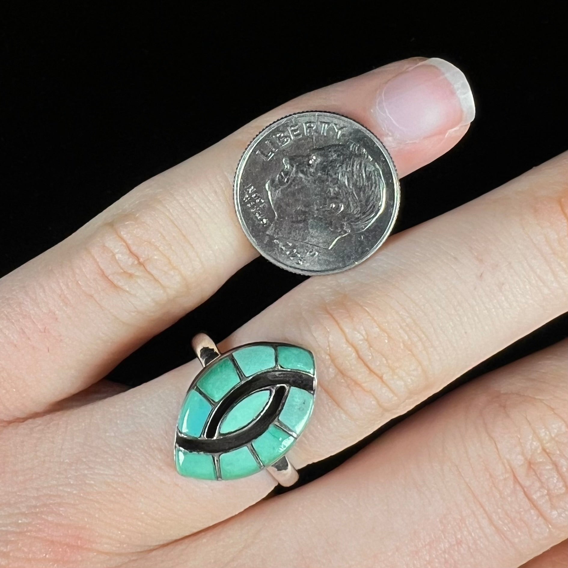 Vintage sterling silver Zuni Indian ring inlay set with green turquoise stones in the motif of a hummingbird.