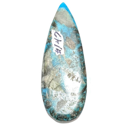 A loose, teardrop shaped, cabochon cut turquoise stone from Kingman, Arizona.  Pyrite inclusions can be seen.