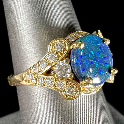 A ladies' 18kt yellow gold Lightning Ridge black opal and pave set diamond ring.