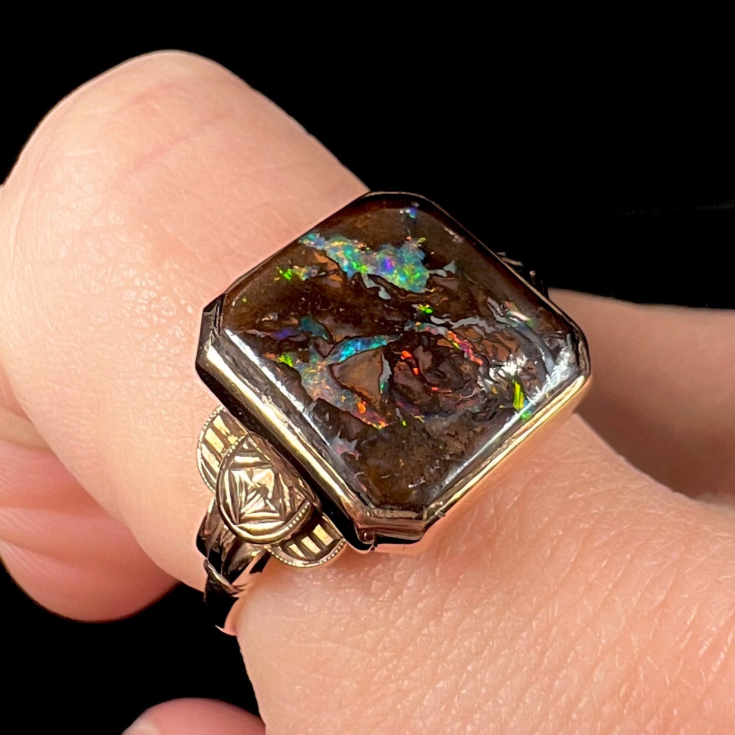 An antique yellow gold boulder opal ring.  The stone is a sqaure cut natural opal from Quilpie, Australia.