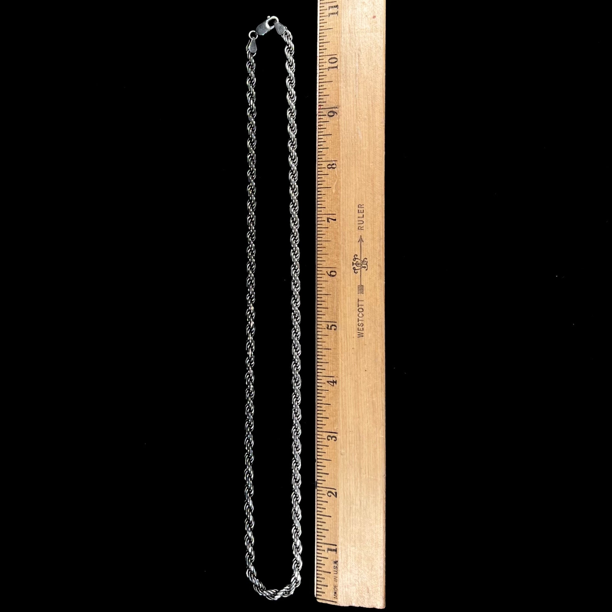 A men's sterling silver rope chain.  The chain measures 22 inches long and 4.5 millimeters wide.