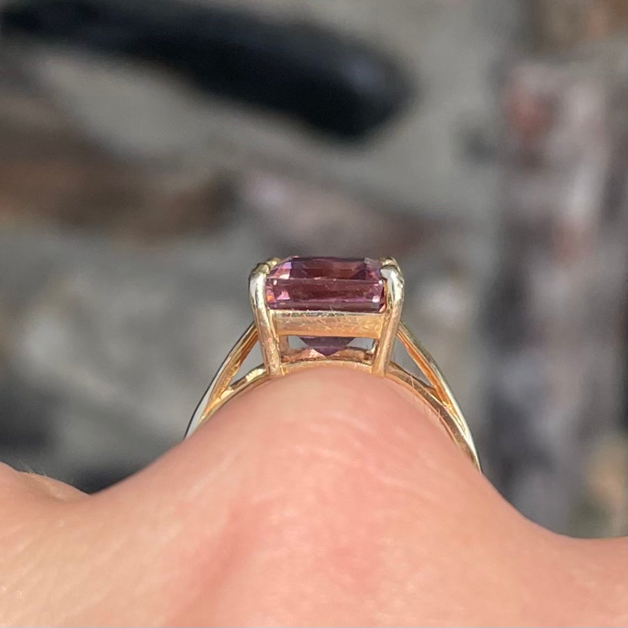 A split shank solitaire ametrine ring made with 14kt yellow gold.