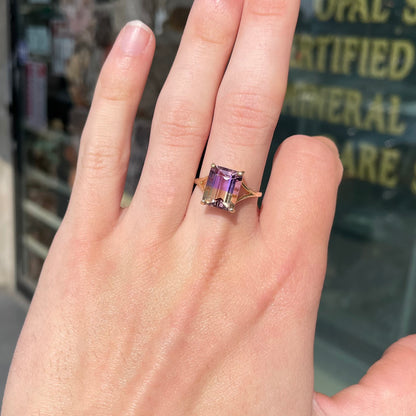 A split shank solitaire ametrine ring made with 14kt yellow gold.