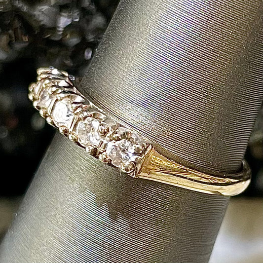 A vintage ladies' five-stone round cut diamond yellow gold wedding band