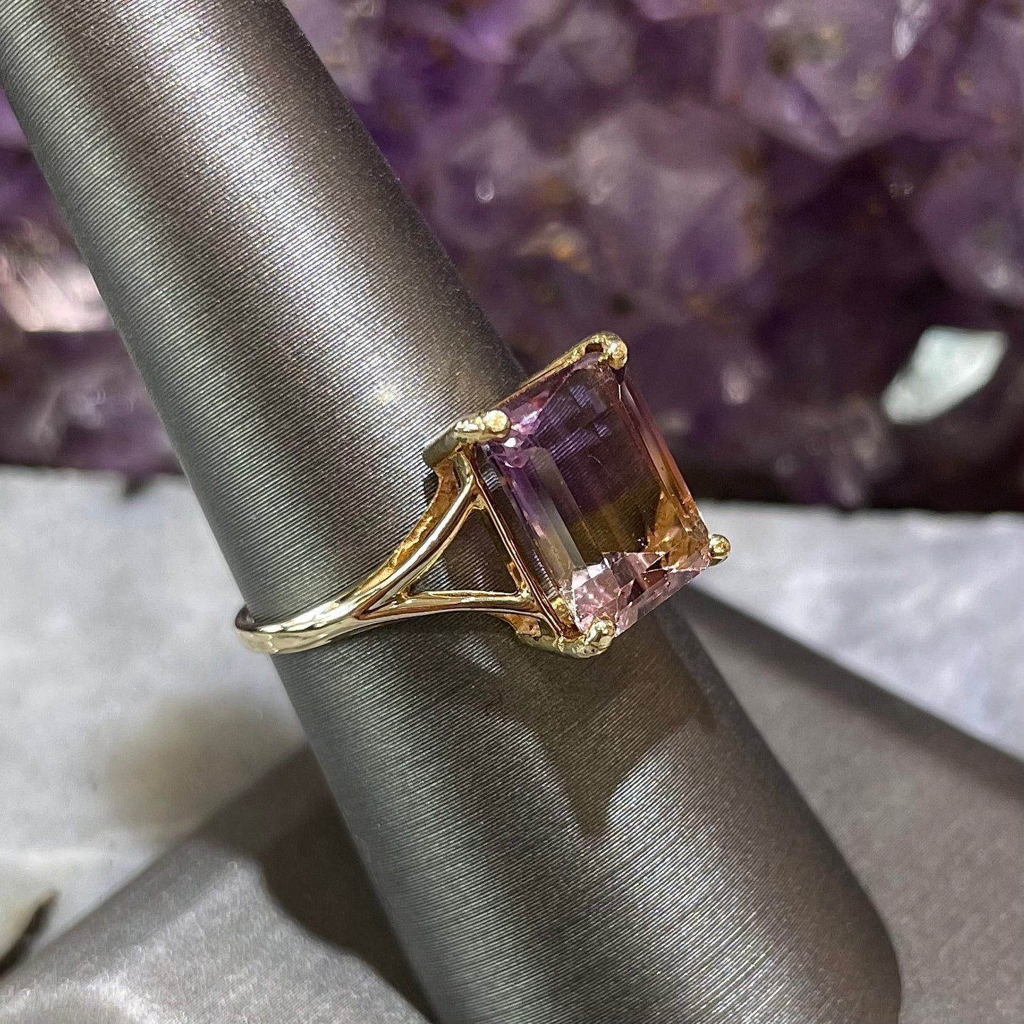 A split shank solitaire ametrine ring made with 14kt yellow gold.