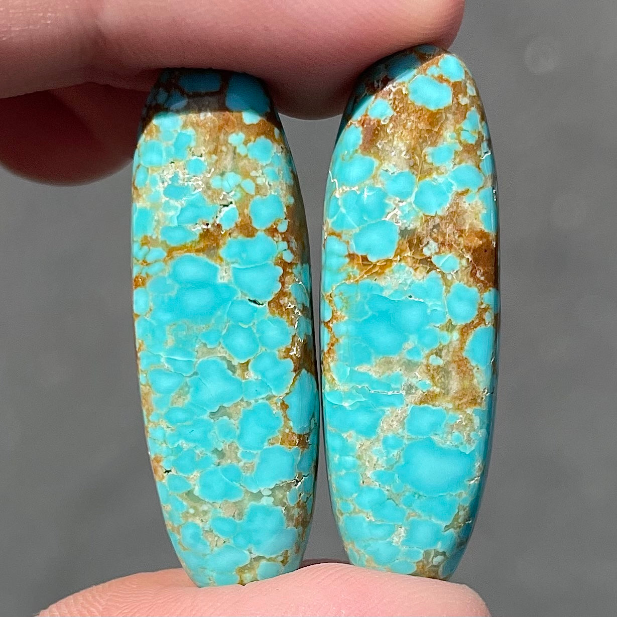 A pair of loose oval cabochon cut turquoise stones from Number 8 Mine, Nevada.